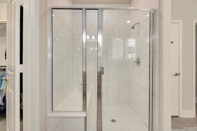 bathroom featuring a shower with door