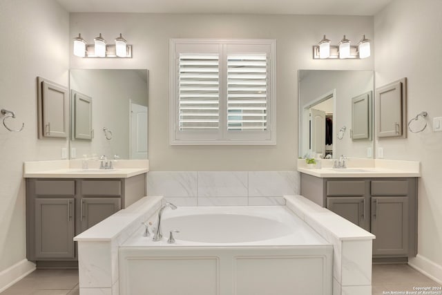 bathroom with a bath, vanity, and tile patterned floors