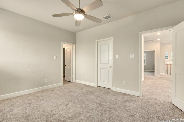 unfurnished bedroom featuring light colored carpet and ceiling fan