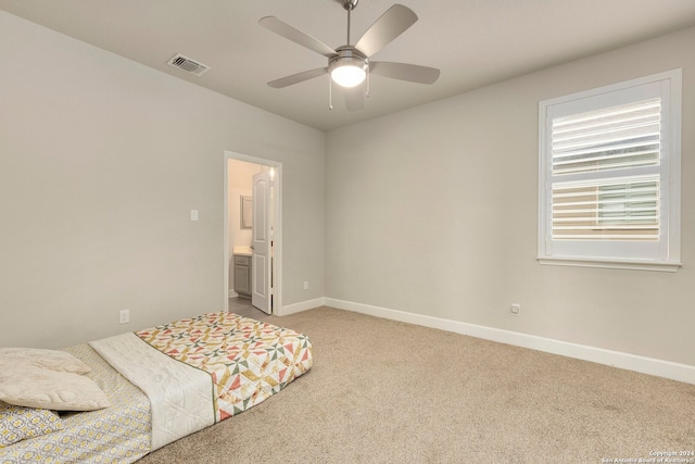 unfurnished bedroom with ensuite bath, ceiling fan, and light colored carpet