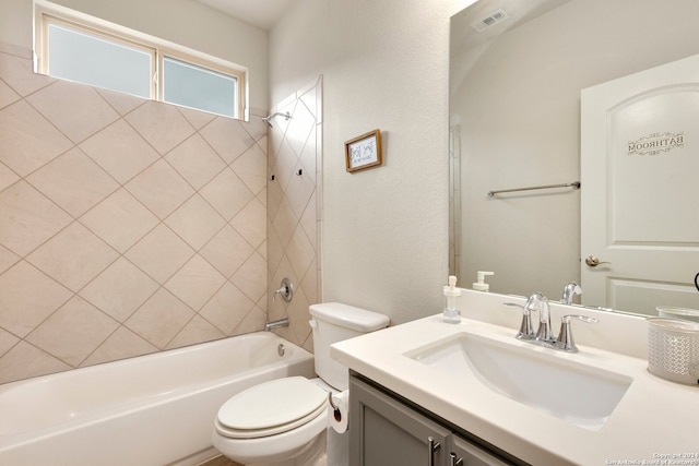 full bathroom featuring vanity, toilet, and tiled shower / bath