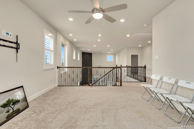 unfurnished room with light carpet and ceiling fan