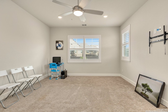 interior space featuring ceiling fan and light colored carpet