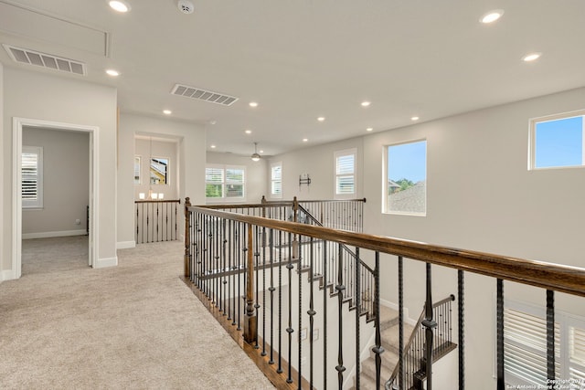 corridor with light colored carpet