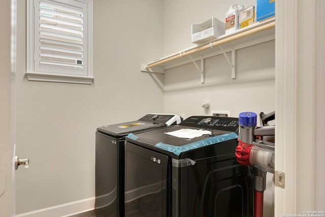 clothes washing area with washer and clothes dryer