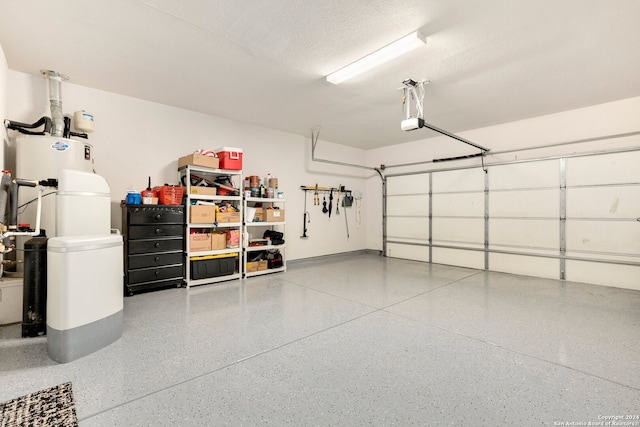 garage featuring a garage door opener and water heater