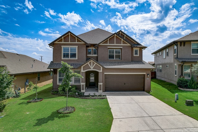 craftsman house featuring a garage and a front lawn