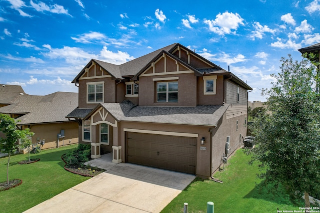 view of front of property with central AC, a garage, and a front lawn