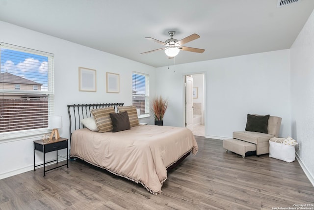 bedroom with wood-type flooring, ensuite bathroom, and ceiling fan