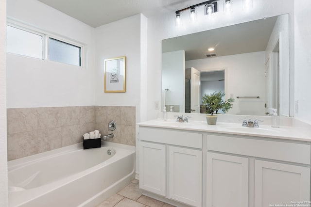 bathroom featuring tile patterned flooring, vanity, and a bathtub