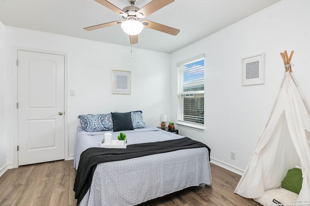 bedroom with ceiling fan and hardwood / wood-style floors