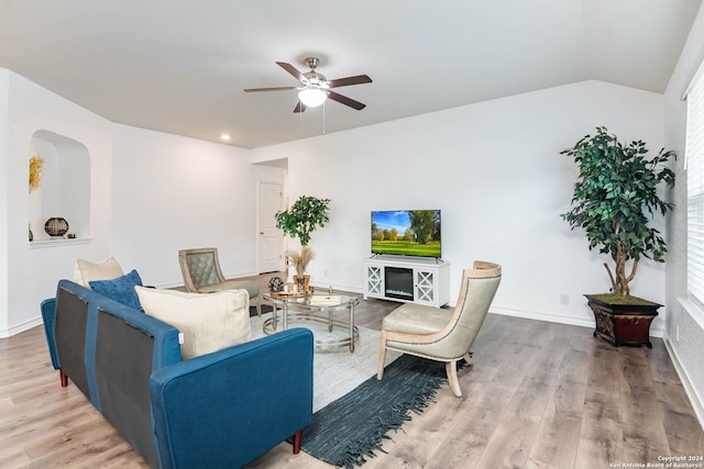 living room featuring ceiling fan, vaulted ceiling, and hardwood / wood-style flooring