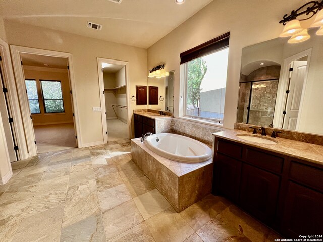 bathroom with vanity and plus walk in shower