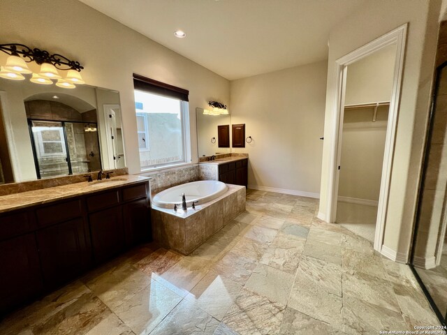 bathroom featuring vanity and shower with separate bathtub