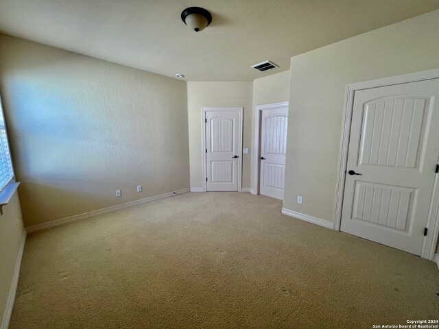 unfurnished bedroom featuring light colored carpet