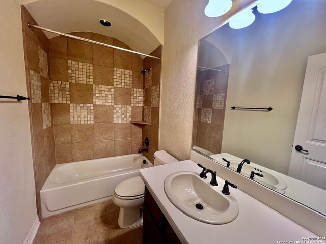 full bathroom featuring tile patterned flooring, tiled shower / bath combo, toilet, and vanity