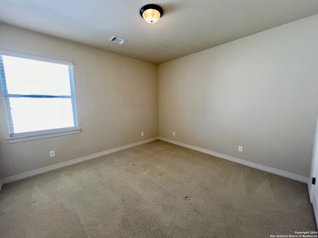 empty room featuring light colored carpet