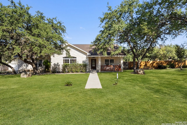 view of front facade featuring a front lawn and a wooden deck