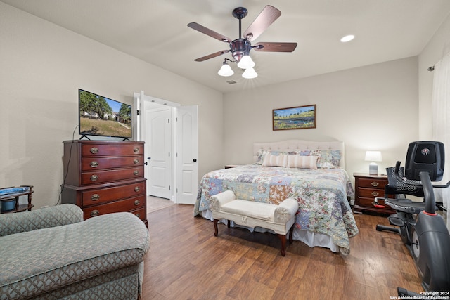 bedroom with ceiling fan and dark hardwood / wood-style flooring