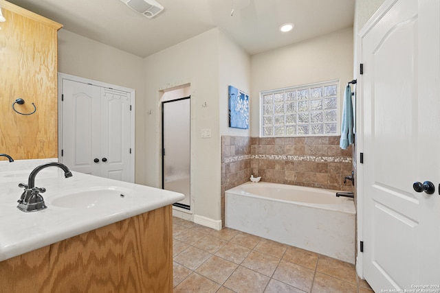 bathroom featuring tile patterned floors, vanity, and a washtub