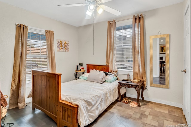 bedroom featuring multiple windows and ceiling fan