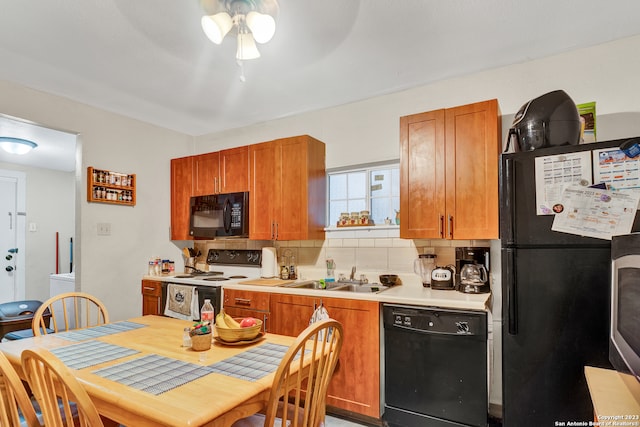 kitchen featuring decorative backsplash, sink, ceiling fan, and black appliances