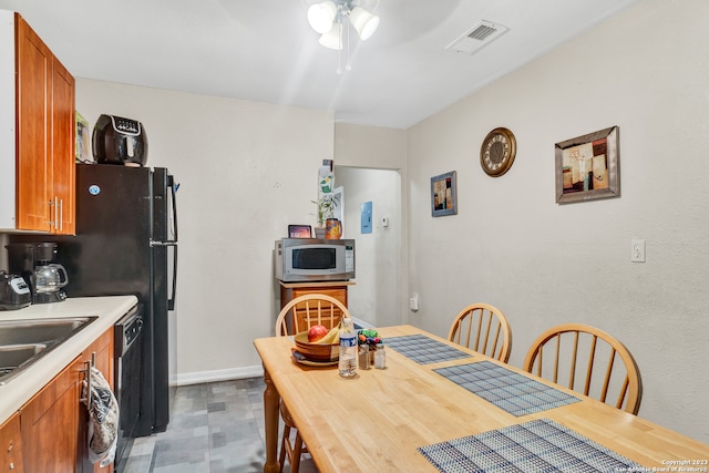 dining area featuring ceiling fan and sink