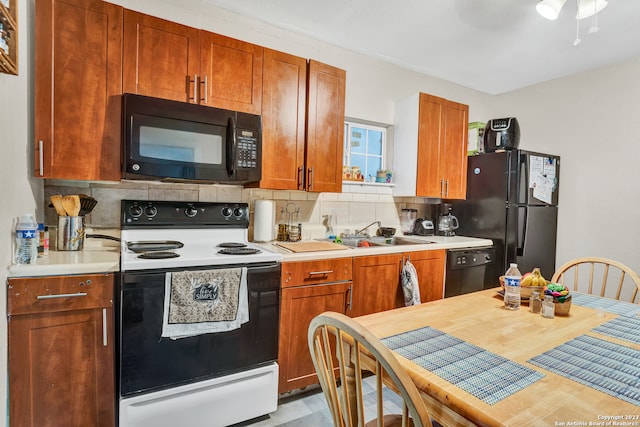 kitchen featuring black appliances, decorative backsplash, ceiling fan, and sink