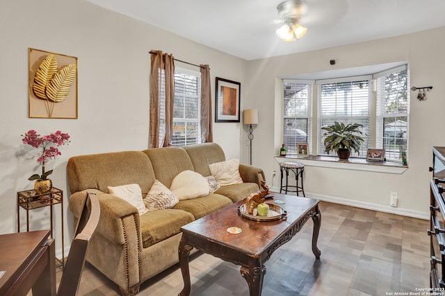 living room with a wealth of natural light and ceiling fan