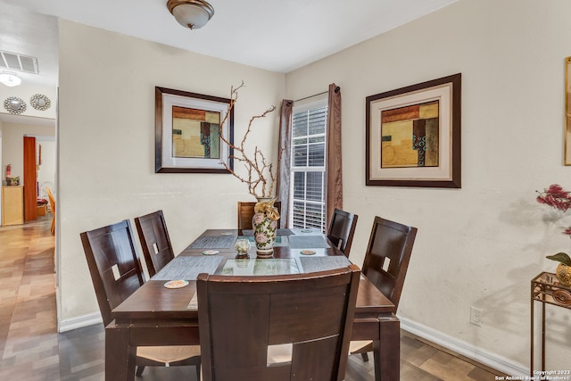 dining area with dark wood-type flooring