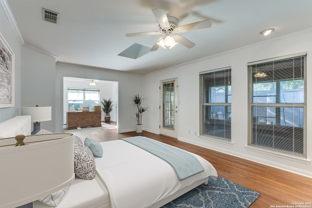 bedroom featuring ceiling fan, wood-type flooring, and ornamental molding