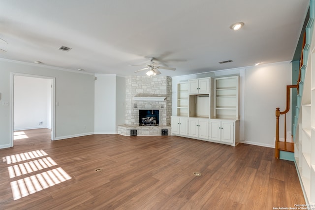 unfurnished living room featuring a fireplace, hardwood / wood-style flooring, ceiling fan, and ornamental molding