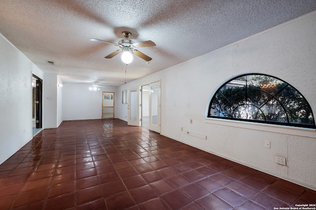 tiled empty room with a textured ceiling and ceiling fan