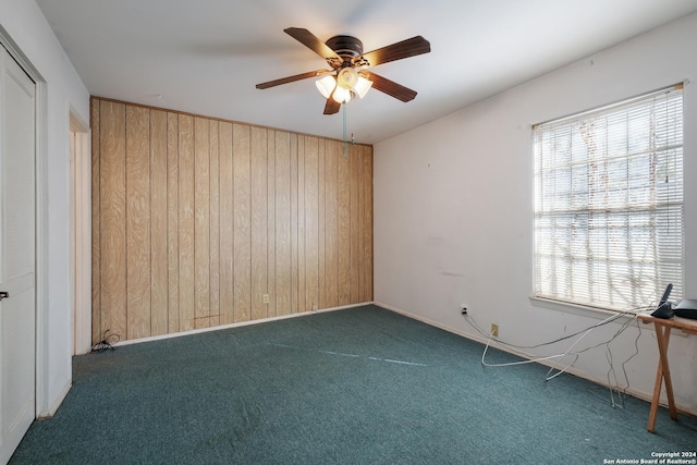 3947 Gayle Ave, San Antonio, TX 78223 - carpeted empty room featuring wood walls, ceiling fan, and baseboards