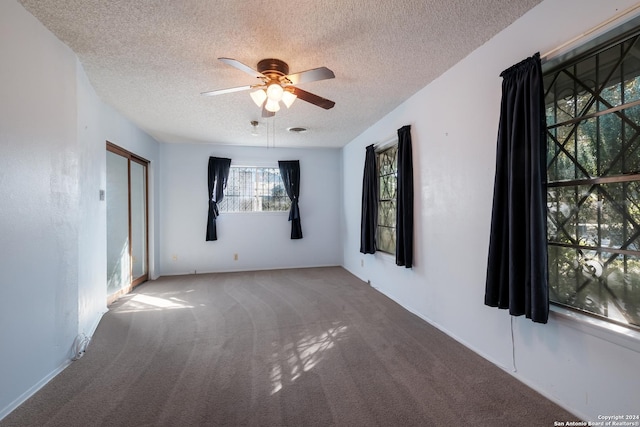 3947 Gayle Ave, San Antonio, TX 78223 - unfurnished room with a textured ceiling, a ceiling fan, and carpet flooring