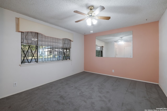 carpeted spare room featuring ceiling fan and a textured ceiling