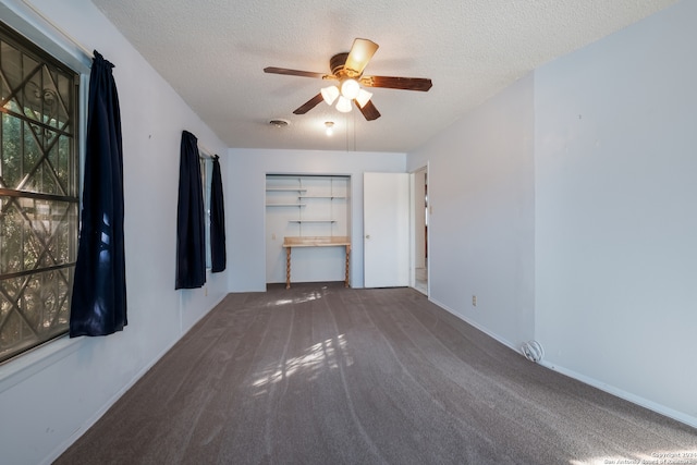 unfurnished room featuring carpet, ceiling fan, and a textured ceiling