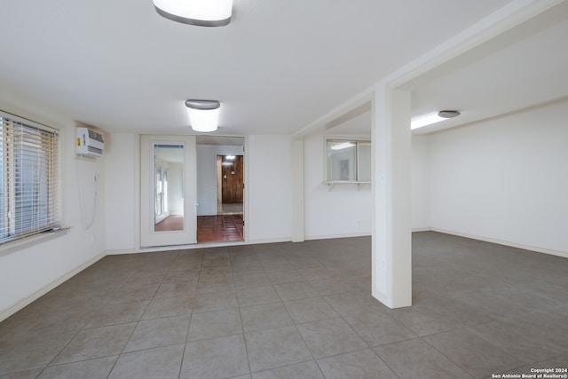 interior space featuring an AC wall unit and light tile patterned flooring