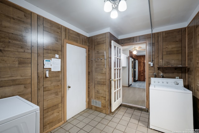 washroom featuring washer / clothes dryer, wood walls, ceiling fan, and light tile patterned floors