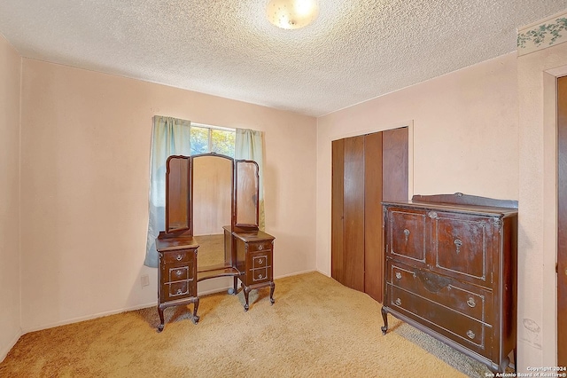 5010 David Scott, Kirby, TX 78219 - bedroom with light colored carpet, a textured ceiling, and a closet