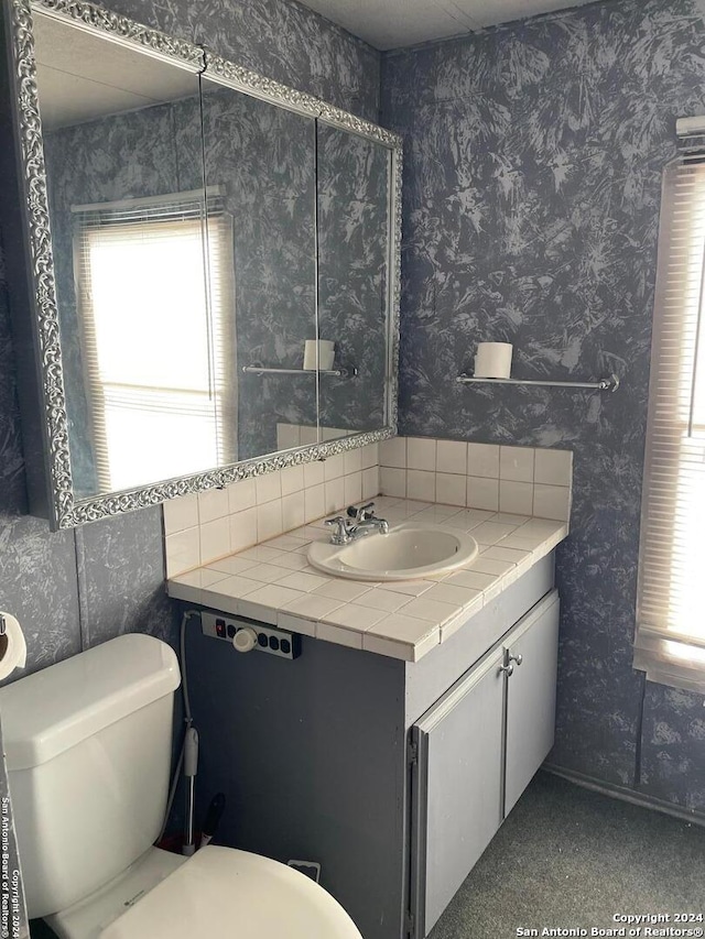 bathroom featuring vanity and toilet