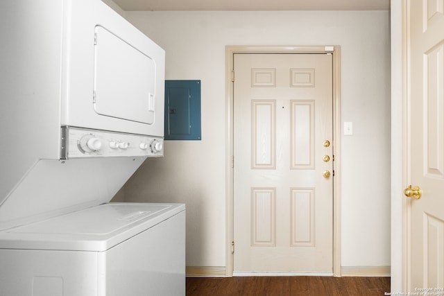 washroom featuring electric panel, stacked washing maching and dryer, and dark wood-type flooring