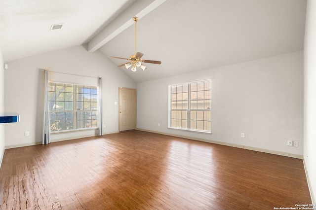 unfurnished living room featuring lofted ceiling with beams, ceiling fan, wood-type flooring, and a wealth of natural light