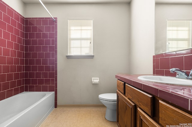 full bathroom featuring vanity, tiled shower / bath combo, toilet, and a healthy amount of sunlight