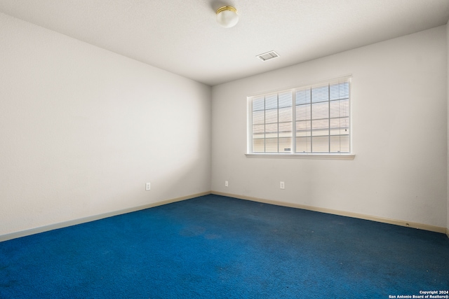 empty room featuring dark carpet