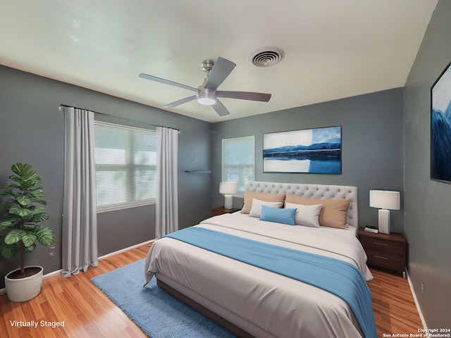 bedroom with light hardwood / wood-style floors and ceiling fan