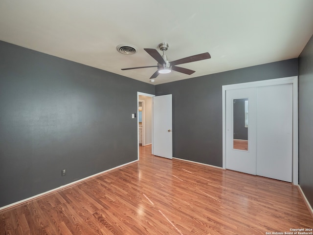 unfurnished bedroom with light wood-type flooring, a closet, and ceiling fan