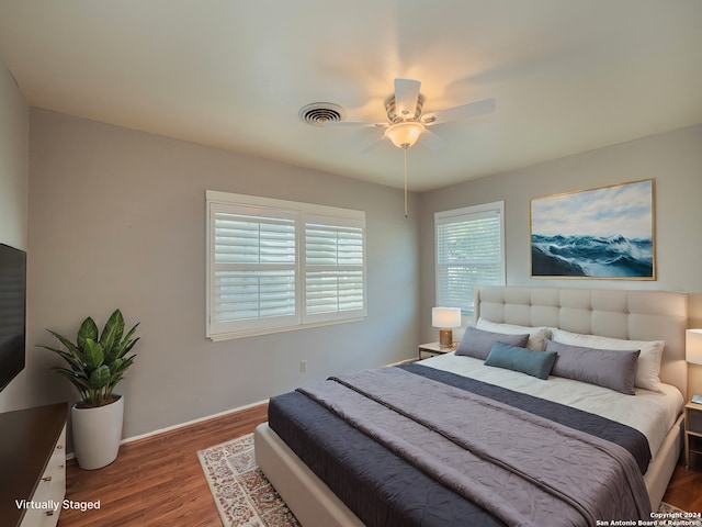 bedroom featuring ceiling fan and dark hardwood / wood-style floors