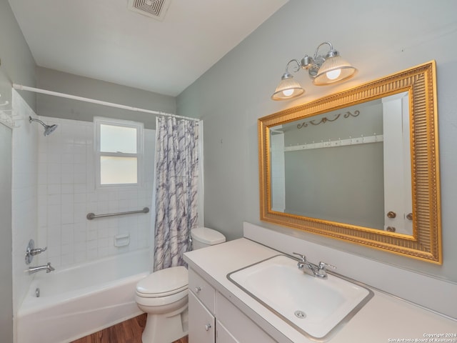 full bathroom with wood-type flooring, vanity, shower / tub combo, and toilet