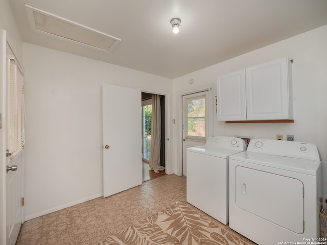 laundry room featuring cabinets and washing machine and dryer